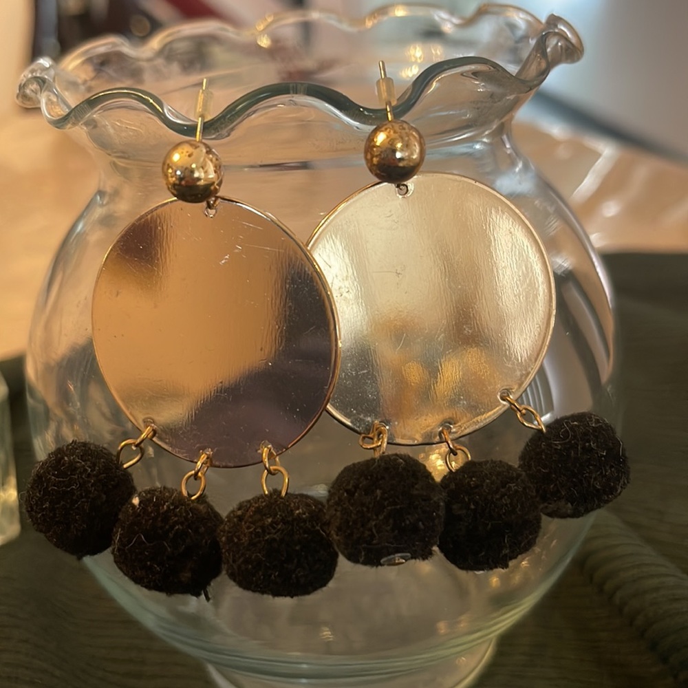 Gold earrings with black pompoms